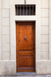 Single wooden door with knocker on Sarrià quarter (Barcelona)