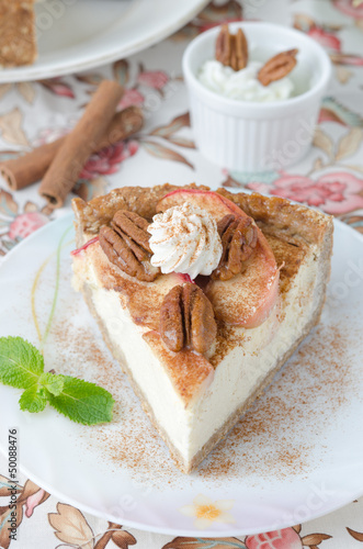 Photo: piece of cheesecake with apples and pecans top view piece of cheesecake with apples and pecans top view