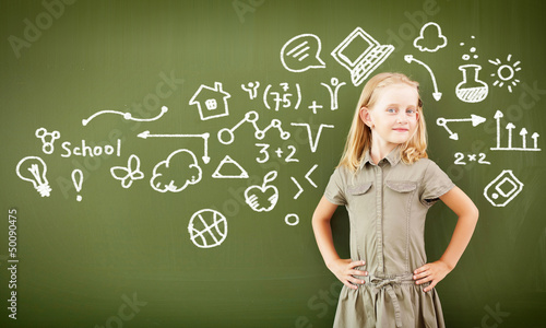 Photo: Scoolgirl standing near blackboard Scoolgirl standing near blackboard