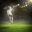 football player striking the ball