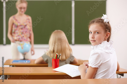 Photo: Little girl at school class Little girl at school class