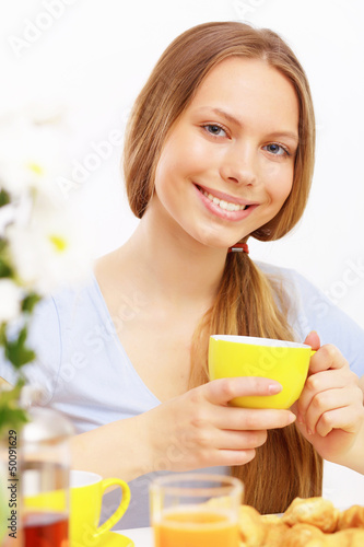Photo: Beautiful young woman drinking tea Beautiful young woman drinking tea