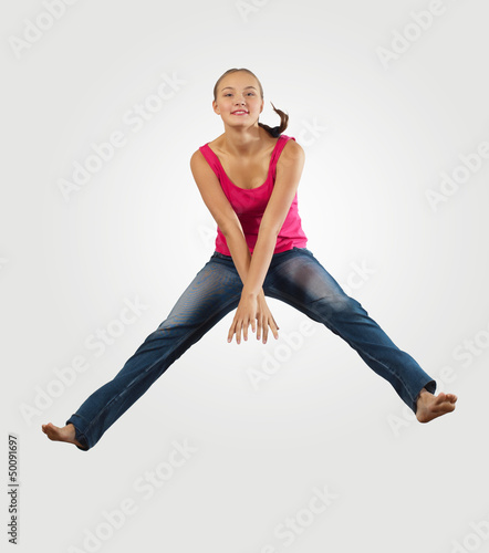 Photo: young woman playing on electro guitar and jumping young woman playing on electro guitar and jumping