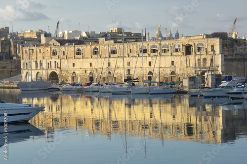 water reflection of old warehouse in Senglea marina in front  Vittoriosa, Malta