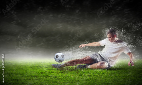 Photo: football player striking the ball football player striking the ball
