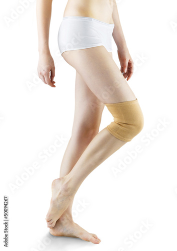 Photo: woman ware knee pad for relief support and protection isolated woman ware knee pad for relief support and protection isolated