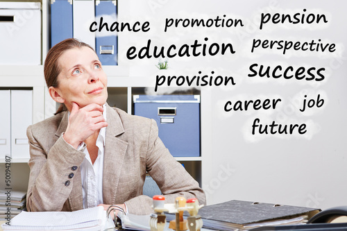 Photo: Senior business woman thinking about career Senior business woman thinking about career