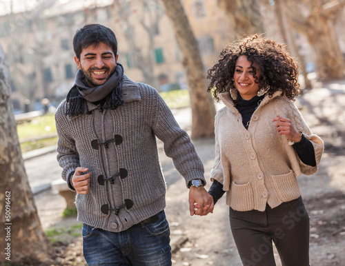 Photo: Young Couple Running in the City Young Couple Running in the City