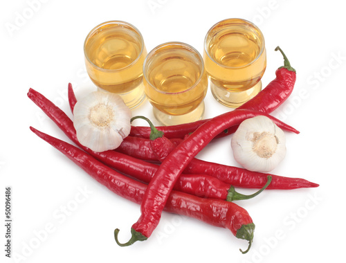 Photo: Tequila cup and red peppers Tequila cup and red peppers