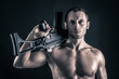 Confident young man shirtless portrait with machine gun