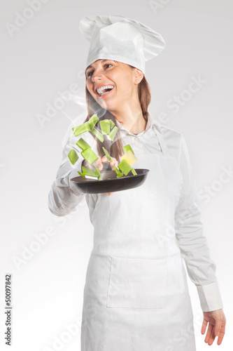 Photo: Happy cook woman holding a pan with creative cuisine Happy cook woman holding a pan with creative cuisine