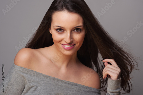Photo: Smiling brunette woman intense close up portrait. Smiling brunette woman intense close up portrait.