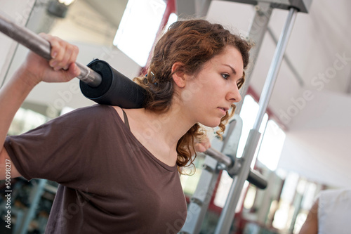 Photo: Young woman training in the gym. Young woman training in the gym.