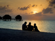 Silhouette of family watching the sun go down