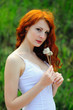 Photo: Redhead girl with dandelions. Redhead girl with dandelions.