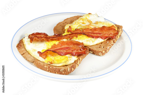 Photo: Two brown bread with fried egg and bacon. Two brown bread with fried egg and bacon.