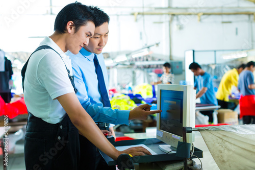 Photo: foreman in a factory explains something foreman in a factory explains something