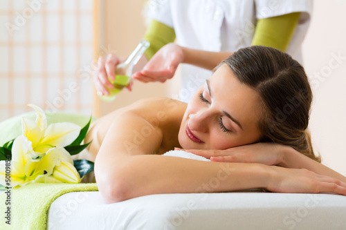 Photo: woman having wellness back massage in spa woman having wellness back massage in spa