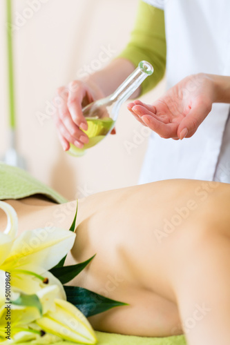 Photo: woman having wellness back massage in spa woman having wellness back massage in spa