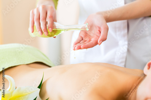 Photo: woman having wellness back massage in spa woman having wellness back massage in spa