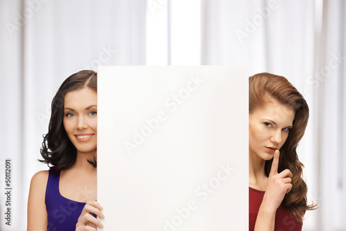 Photo: two women with blank board two women with blank board