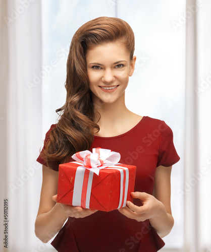 Photo: teenage girl in red dress with gift box teenage girl in red dress with gift box