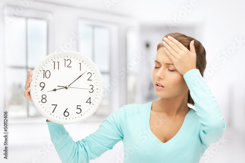 Photo: woman holding big clock woman holding big clock
