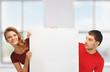 man and woman with big blank board