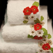 Photo: white, clean towel decorated by flowers white, clean towel decorated by flowers