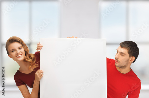 Photo: man and woman with big blank board man and woman with big blank board