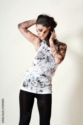 Photo: woman with face and body covered in mud woman with face and body covered in mud