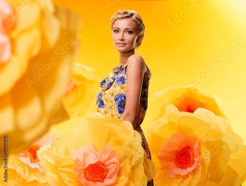 Photo: Beautiful young blond woman in colourful dress Beautiful young blond woman in colourful dress