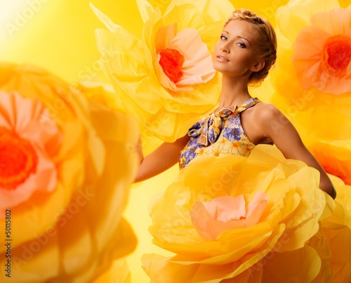 Photo: Beautiful young blond woman in colourful dress Beautiful young blond woman in colourful dress