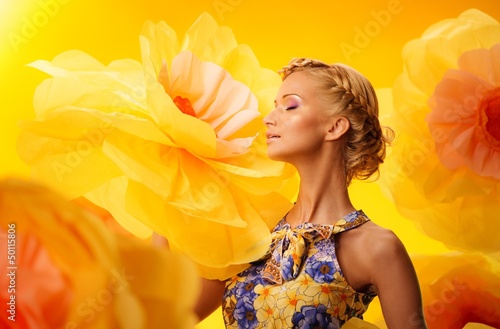 Photo: Beautiful young blond woman in colourful dress Beautiful young blond woman in colourful dress