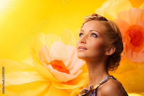 Photo: Beautiful young blond woman in colourful dress Beautiful young blond woman in colourful dress