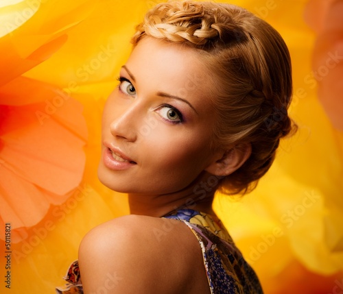 Photo: Beautiful young cheerful blond woman in colorful dress Beautiful young cheerful blond woman in colorful dress