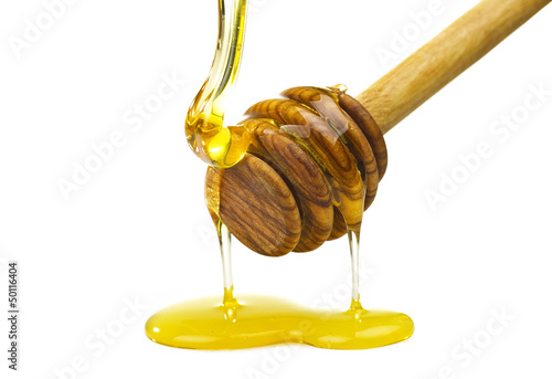 Photo: Honey dripping from a wooden of olives dipper Honey dripping from a wooden of olives dipper