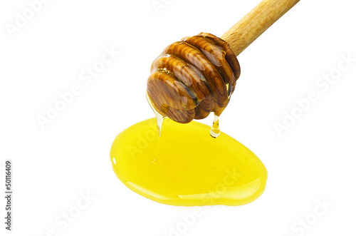 Photo: Honey dripping from a wooden of olives dipper Honey dripping from a wooden of olives dipper