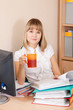 businesswoman reading documents and drinking tea