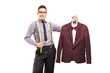 Male fashion designer holding a suit on a hanger