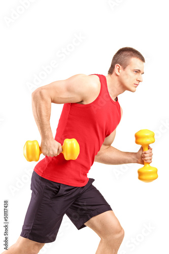 Photo: Muscular athletic man lifting weights Muscular athletic man lifting weights