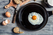 Closeup of fried egg on a cast iron pan