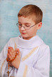 boy going to the first holy communion with a rosary