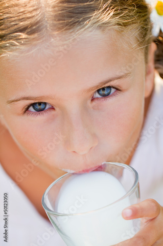 Photo: Healthy kid - lovely girl drinking fresh milk Healthy kid - lovely girl drinking fresh milk