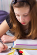 Photo: Cute girl with school books doing homework Cute girl with school books doing homework
