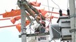 Electricians repairing power transformer.