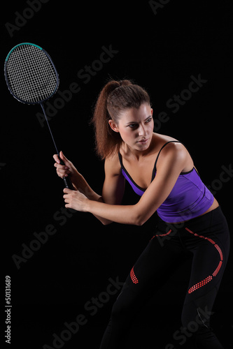 Photo: woman with badminton racket isolated on black woman with badminton racket isolated on black