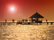 Boat dock in silhouette on small pacific island