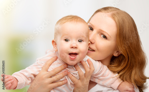 Photo: happy family. young mother with baby happy family. young mother with baby