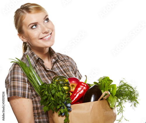 Photo: Young woman with a grocery shopping bag. Isolated on white backg Young woman with a grocery shopping bag. Isolated on white backg